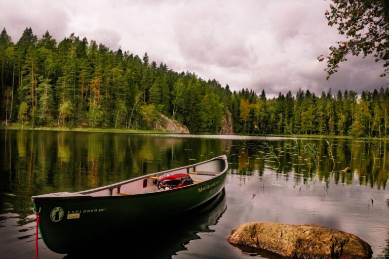 An empty canoe floating on a still lake