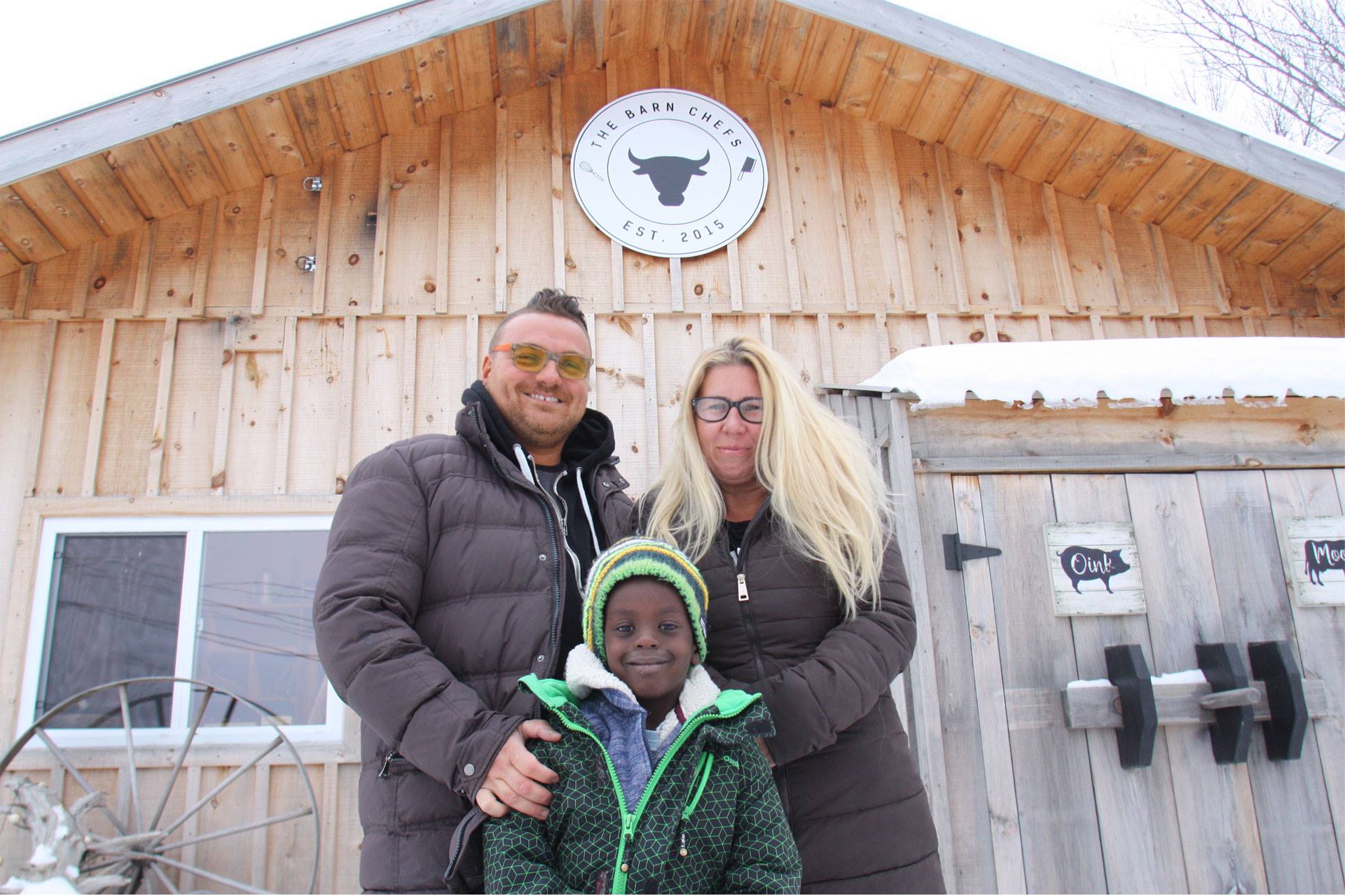 The owners of The Barn Chefs posing for the camera in front of their business.