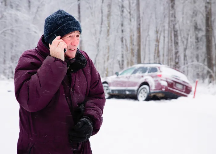 Man on phone with broken down car