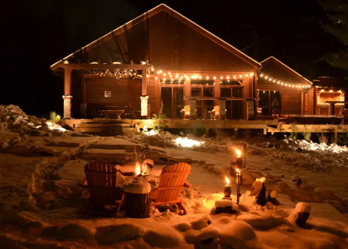 Black River Retreat lit up at night in the Winter in Tweed, Ontario