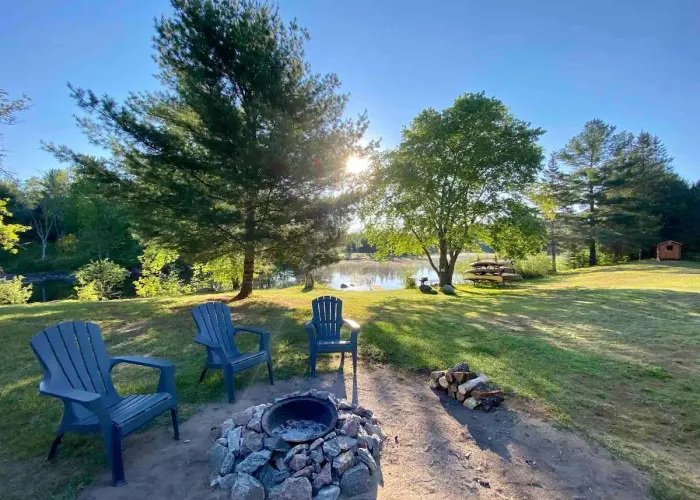 Adirondack Chairs around the firepit at York River Cottages outside Bancroft, Ontario Cottage Country