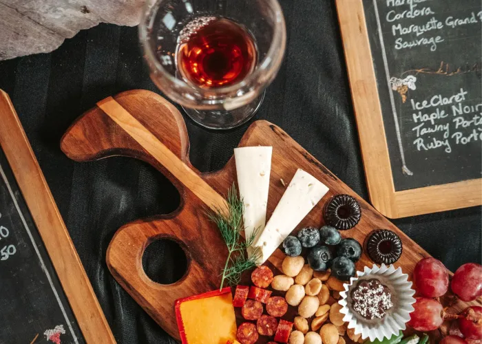 top view of charcuterie board on table with wine and menus