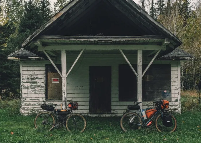 abandoned building with bikes leaning against it