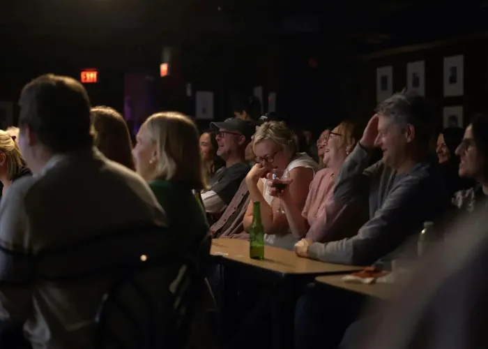 Crowd of people sitting and laughing together