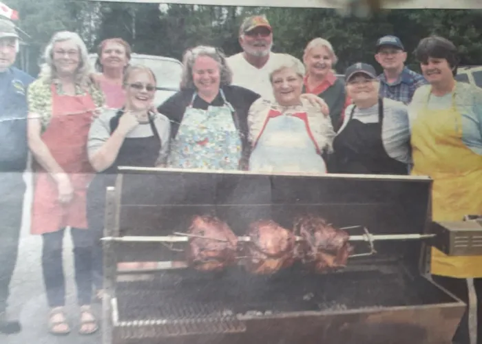 Photo of Limerick Friends Club Members standing behind Bbq