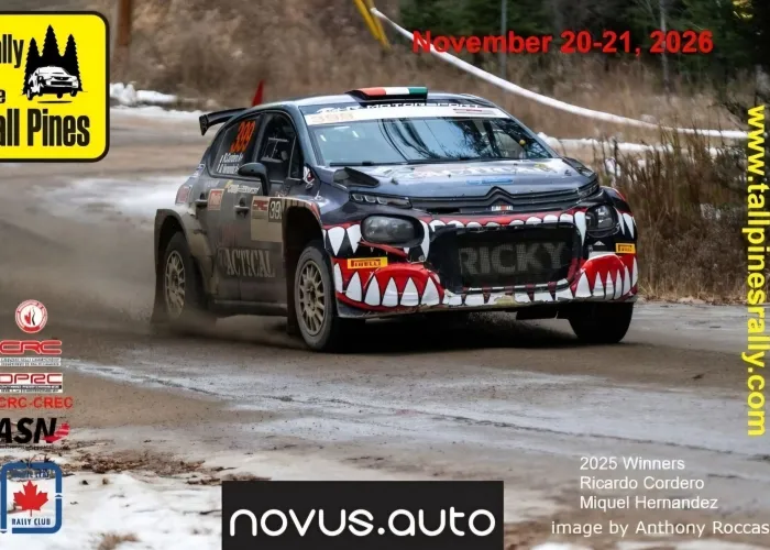 Photo of race care with teeth on front and sponsor stickers all over, yellow rally of tall pines logo top left