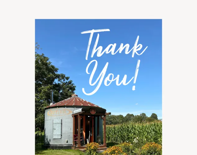 A grain bin with a field and blue sky in the background. The words Thank You! are written over top.